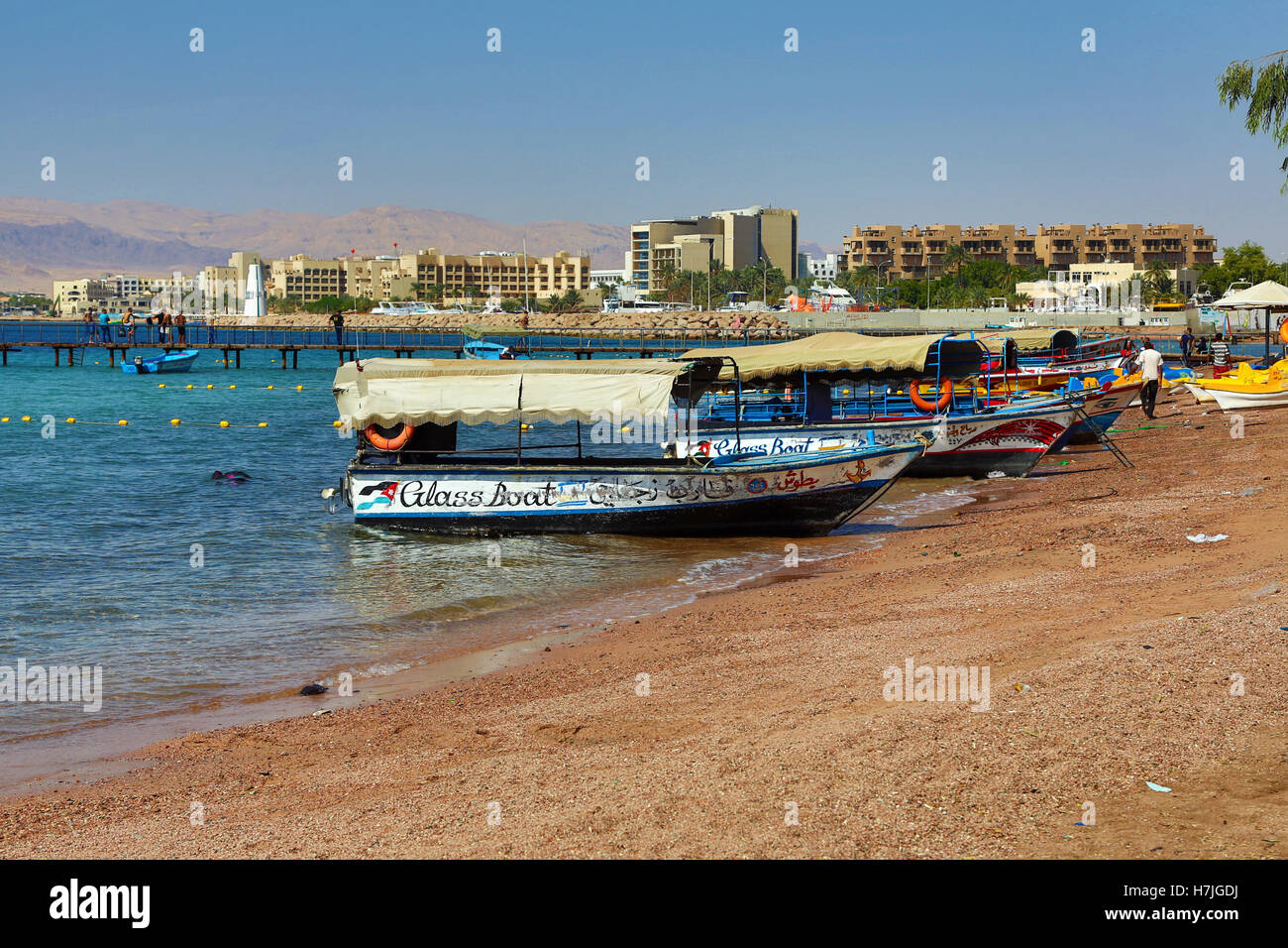 The beach at Aqaba in Jordan looking towards Eilat in Israel Stock Photo