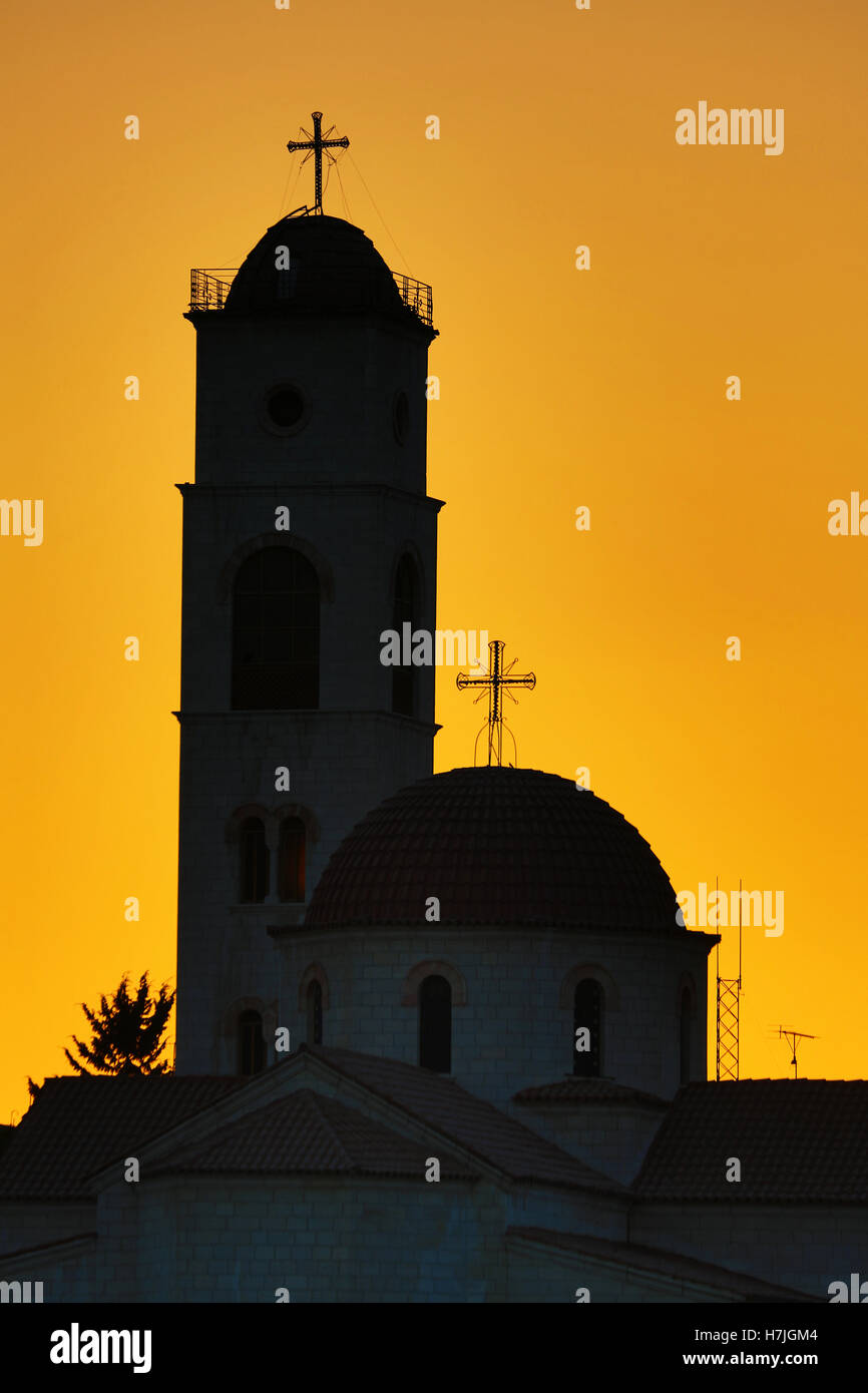 Silhouette of the Greek Orthodox Church dome and tower at sunset in Amman, Jordan Stock Photo