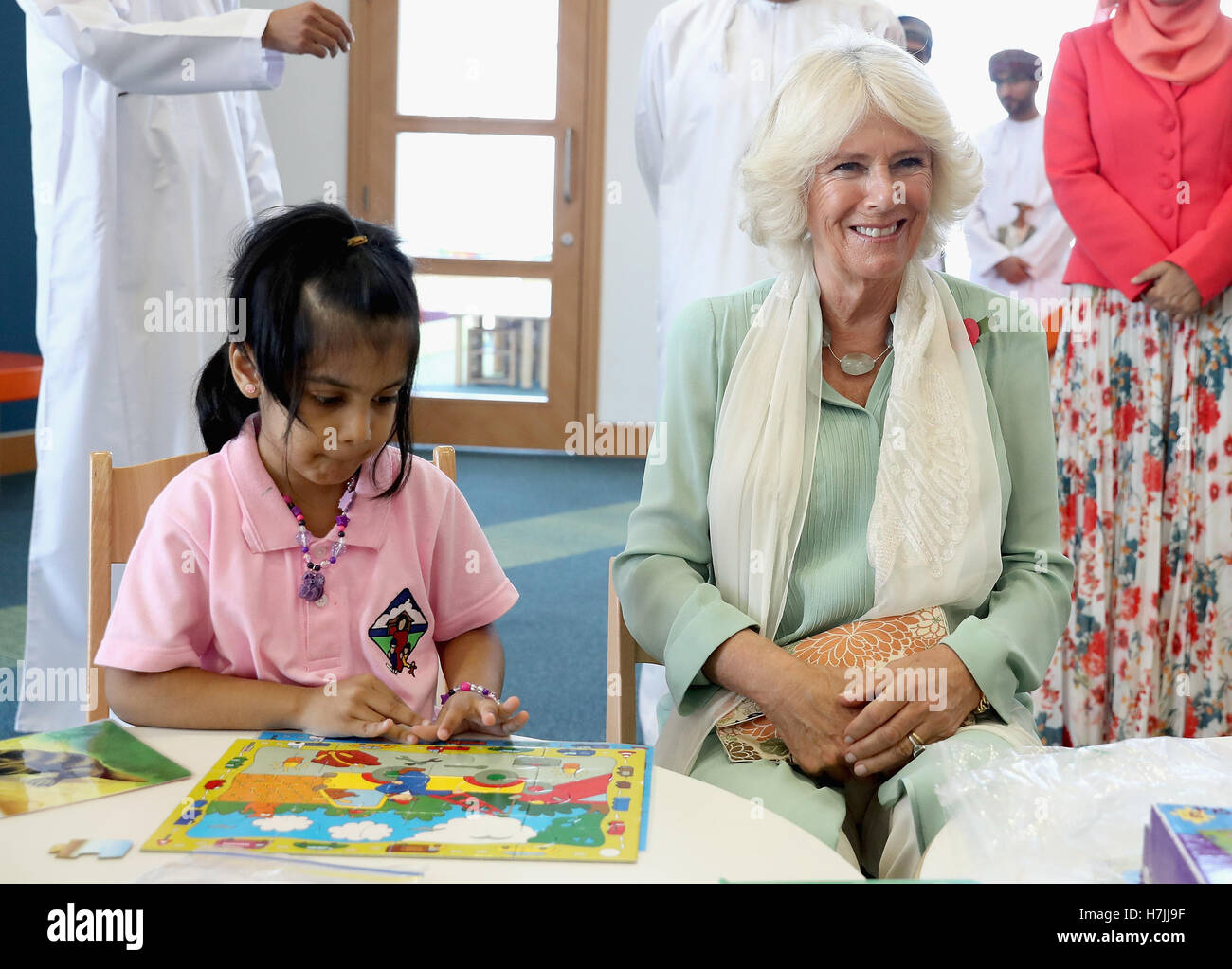The Duchess of Cornwall completes a puzzle with a young girl as she ...