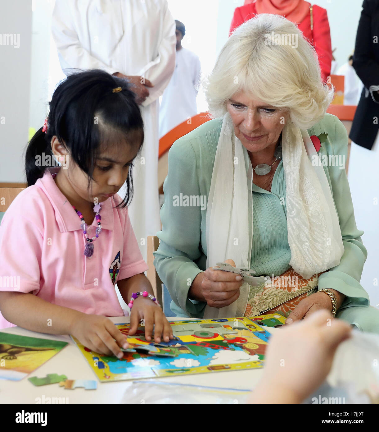 The Duchess of Cornwall completes a puzzle with a young girl as she ...