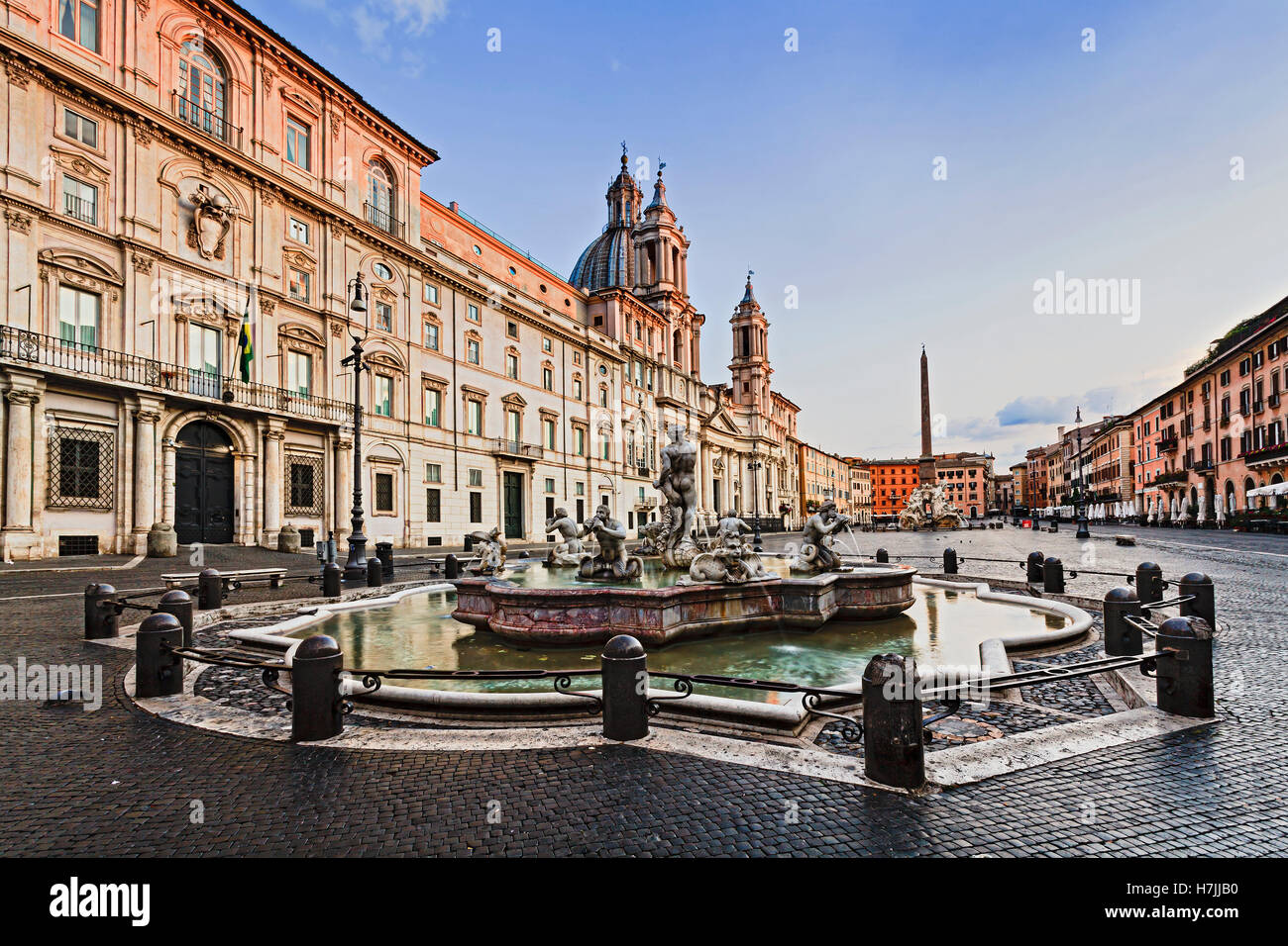 vista of Navona square in Rome from fountain del Moro towards St Agnese church and surrounding historic houses Stock Photo