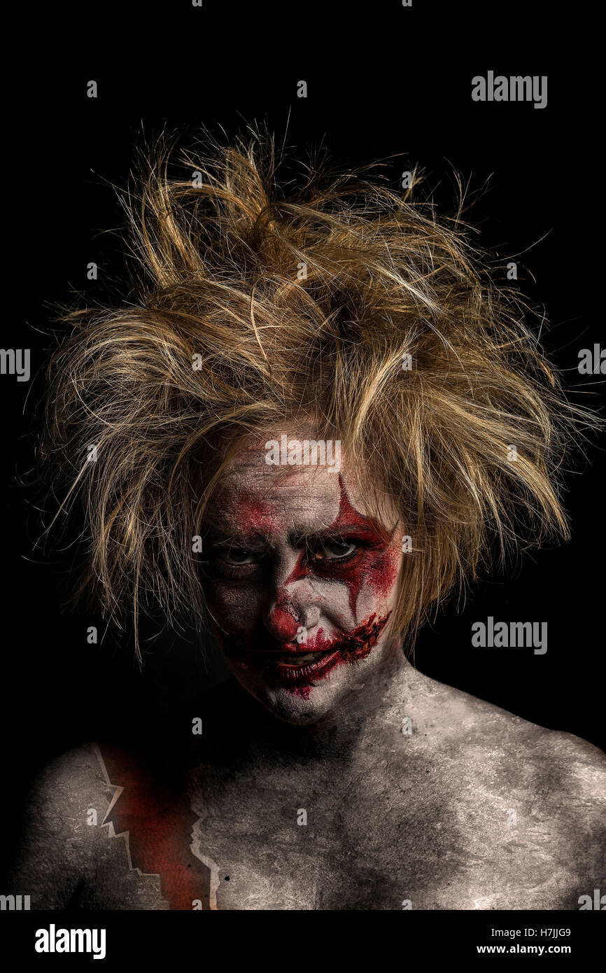 Blonde female model as bloodstained, crazed, insane, murderous clown Stock Photo