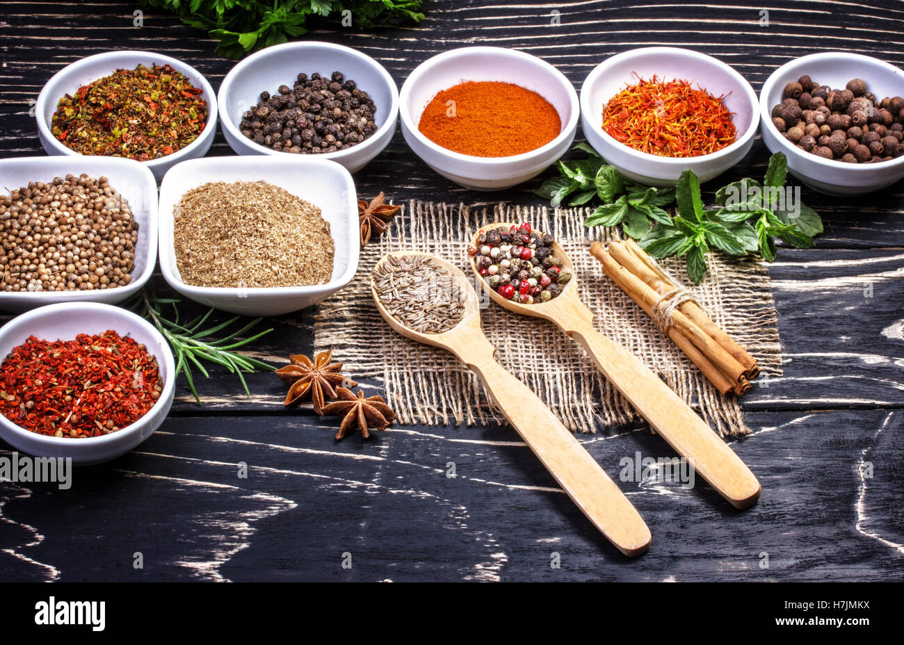 Colorful aromatic  spices and herbs on an old oak wooden brown backgrownd Stock Photo
