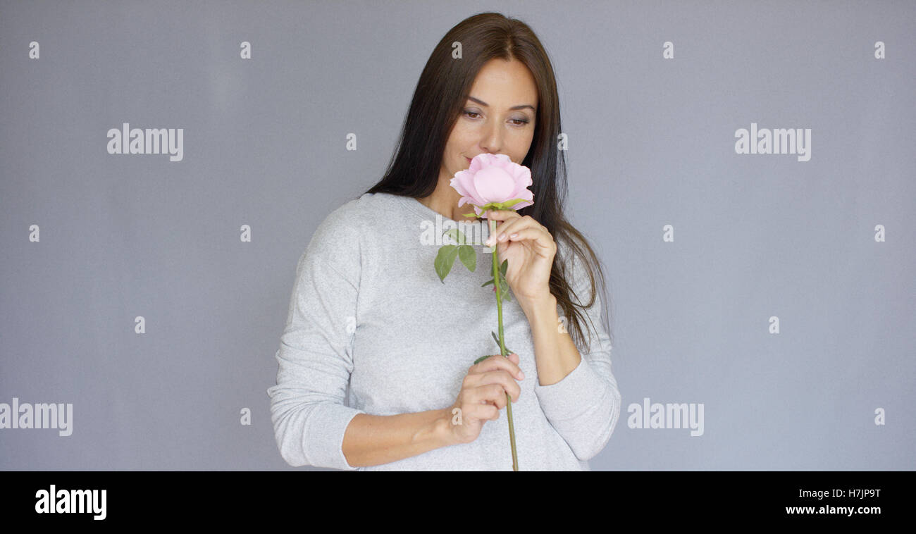 Elegant beautiful woman holding rose flower Stock Photo