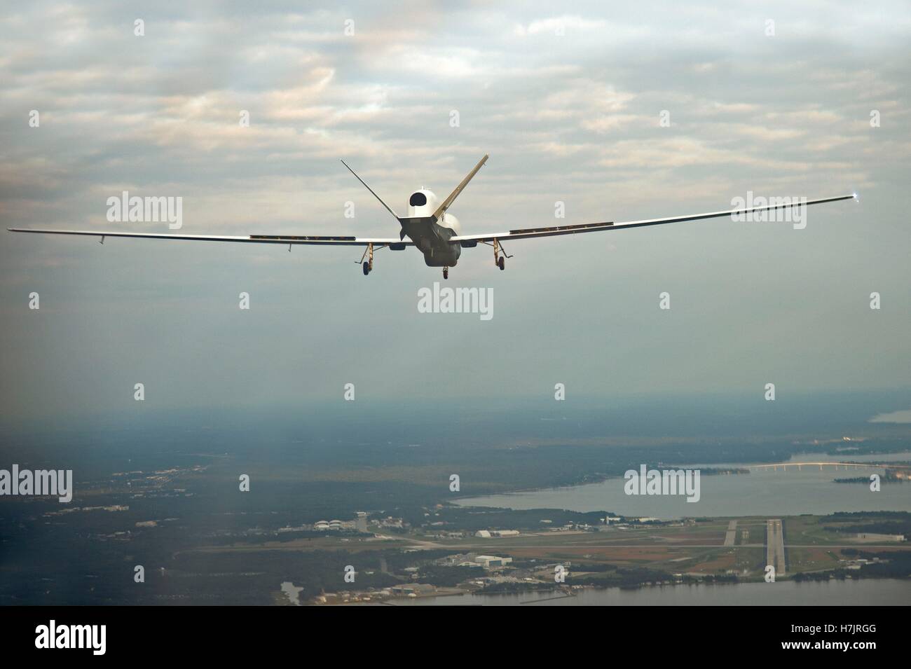 The MQ-4C Triton unmanned aircraft nears the Naval Air Station Patuxent River after completing its inaugural cross-country flight from California September 18, 2014 in Maryland. Stock Photo