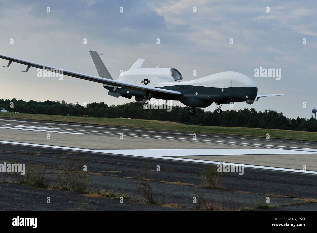 The MQ-4C Triton unmanned aircraft prepares to land on the runway at the Naval Air Station Patuxent River after completing its inaugural cross-country flight from California September 18, 2014 in Maryland. Stock Photo