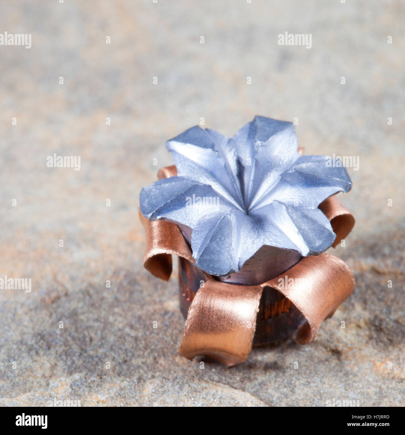 Copper jacketed hollow point that has expanded on impact Stock Photo