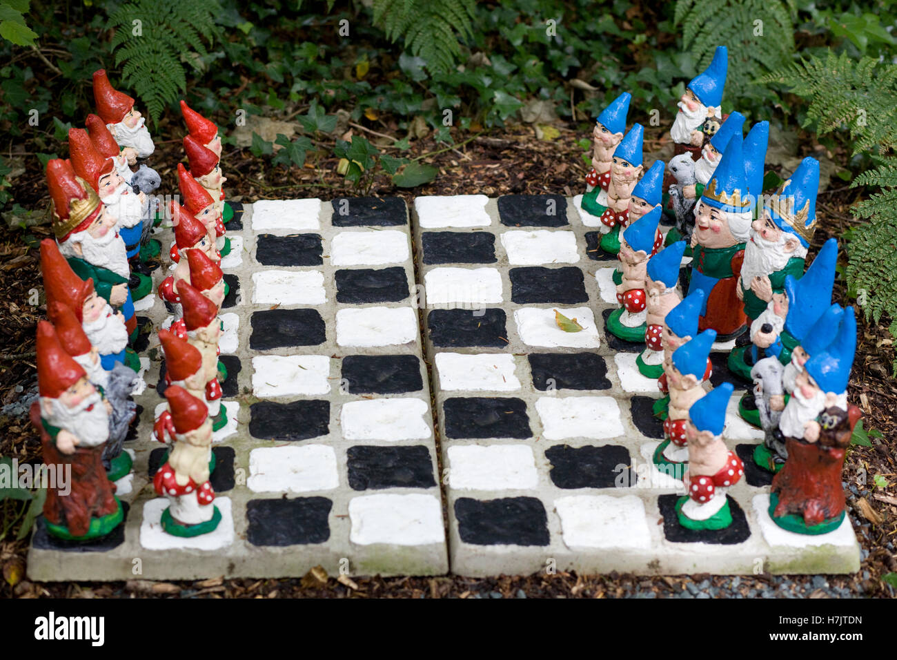 garden gnome chess pieces and board Stock Photo