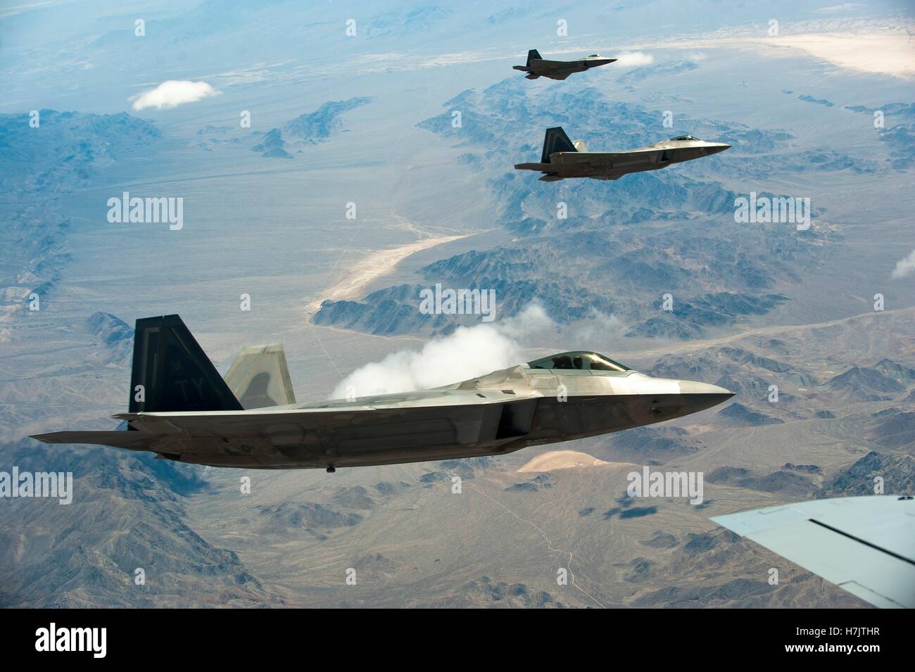 F-22 Raptor stealth fighter aircraft fly over the Nevada Test and Training Range during exercise Red Flag July 17, 2014 in Nevada. Stock Photo