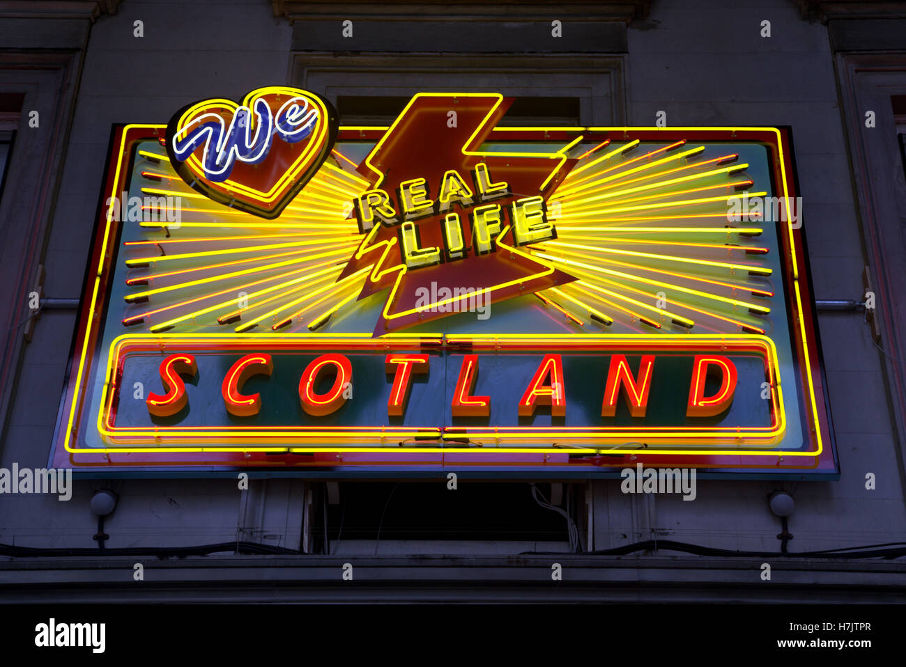 we love real life Scotland outside museum neon exhibit Stock Photo