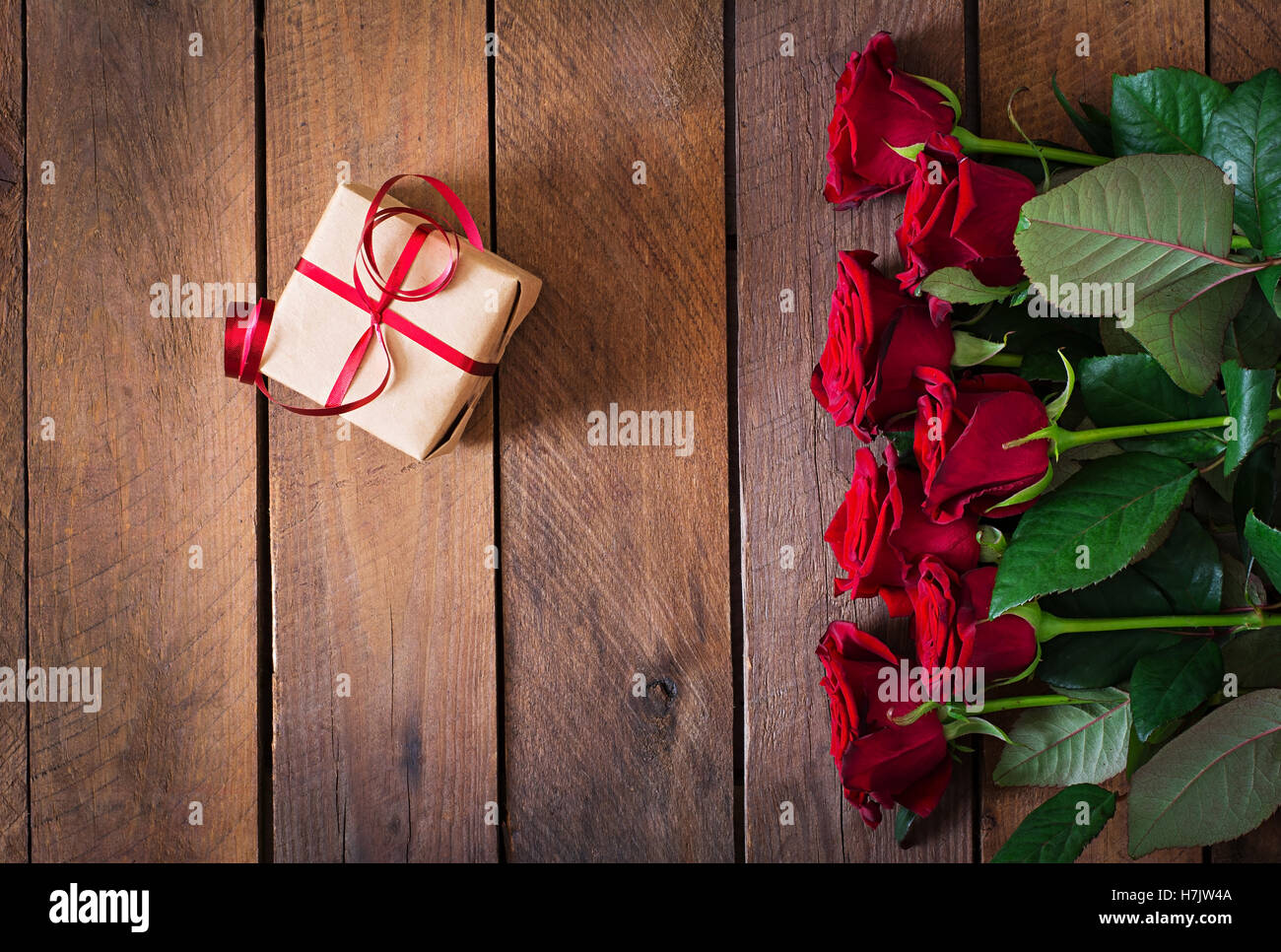 Bouquet of red roses on a dark wooden background. Top view Stock Photo ...