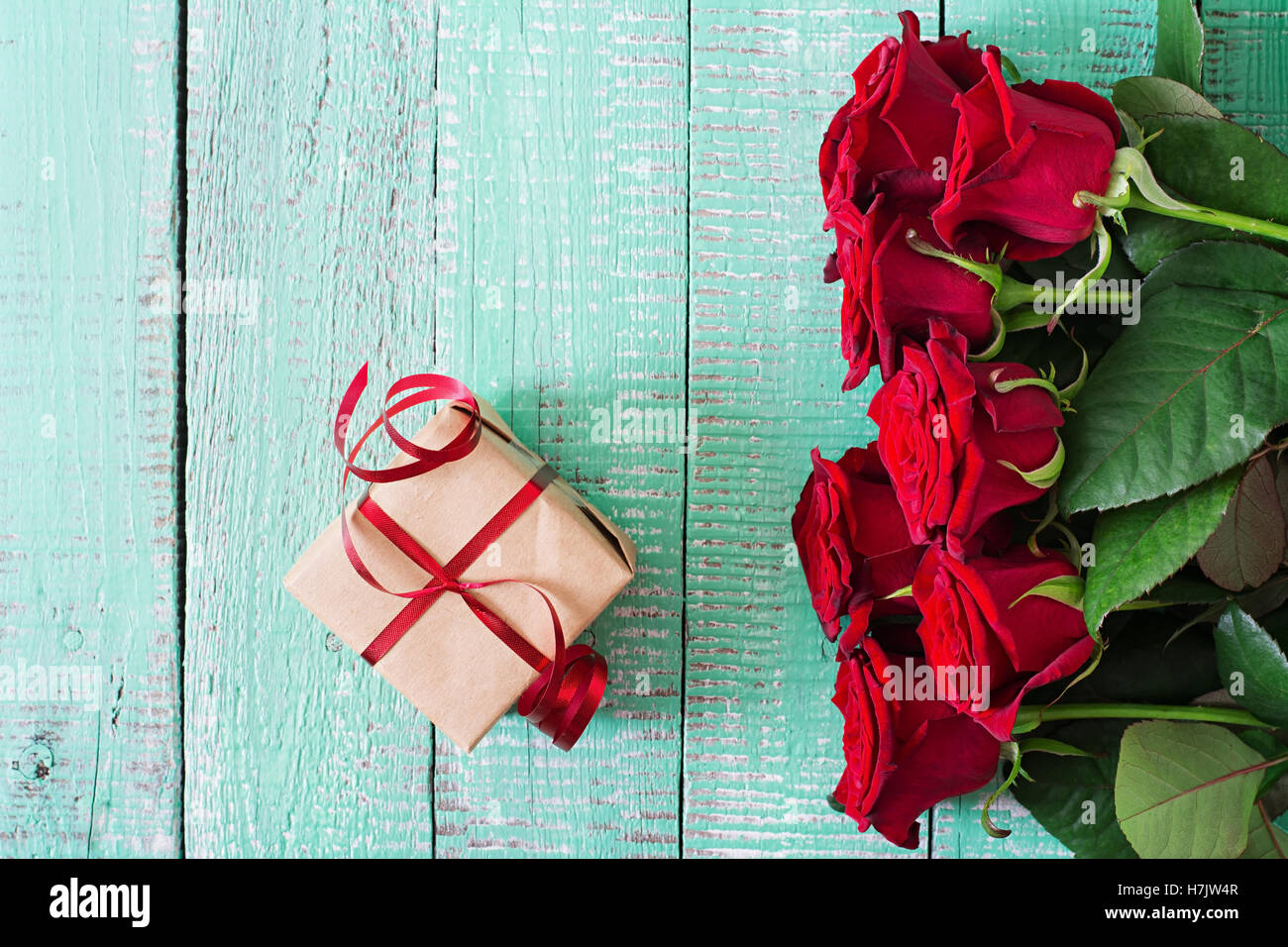 Bouquet of red roses on a light wooden background. Top view Stock Photo ...