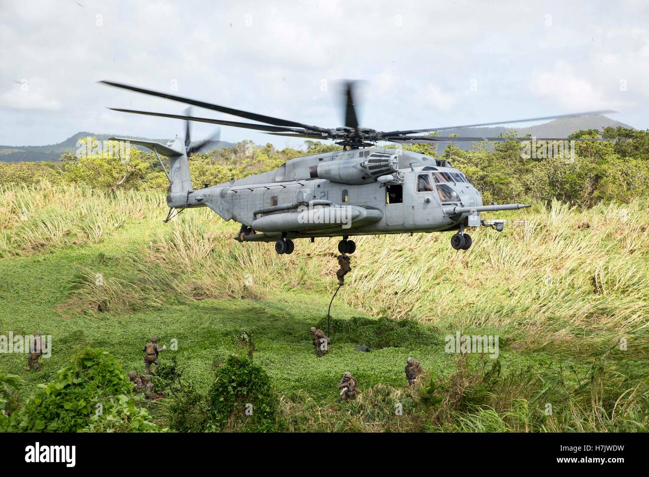 U.S. soldiers fast-rope descend from a CH-53 Super Stallion helicopter during a hostage village training scenario at the Central Training Area July 18, 2014 in Okinawa, Japan. Stock Photo