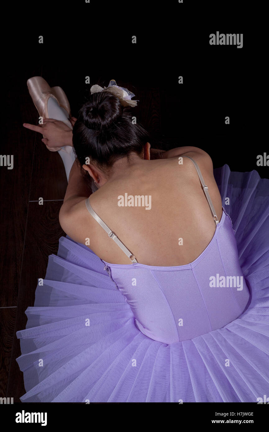 Young Ballerina wearing pointe shoes and tutu in dance pose Stock Photo
