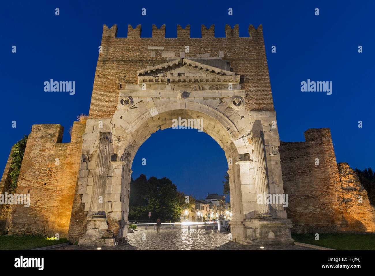 Arch of Augustus at night in Rimini, Italy. Ancient romanesque gate of the city - historical landmark, the most ancient roman ar Stock Photo