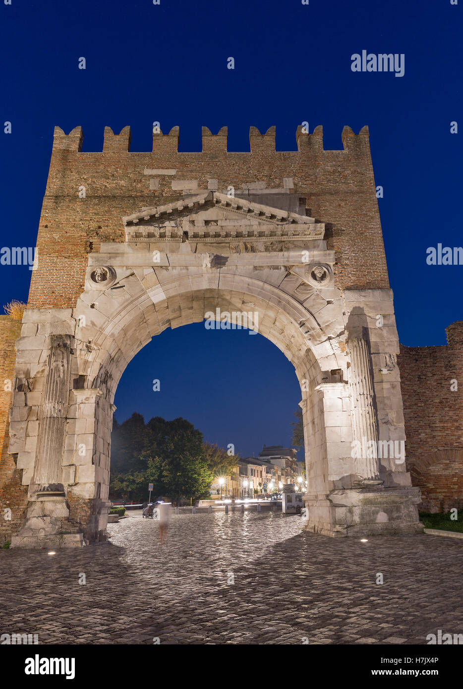 Arch of Augustus at night in Rimini, Italy. Ancient romanesque gate of
