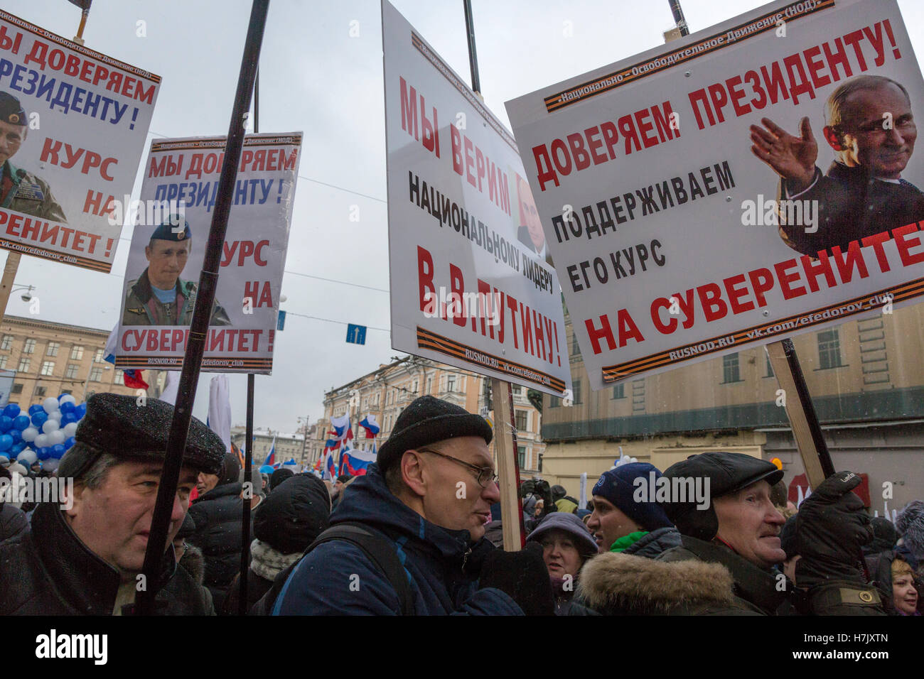 People Hold Banners With Portraits Of Vladimir Putin During The