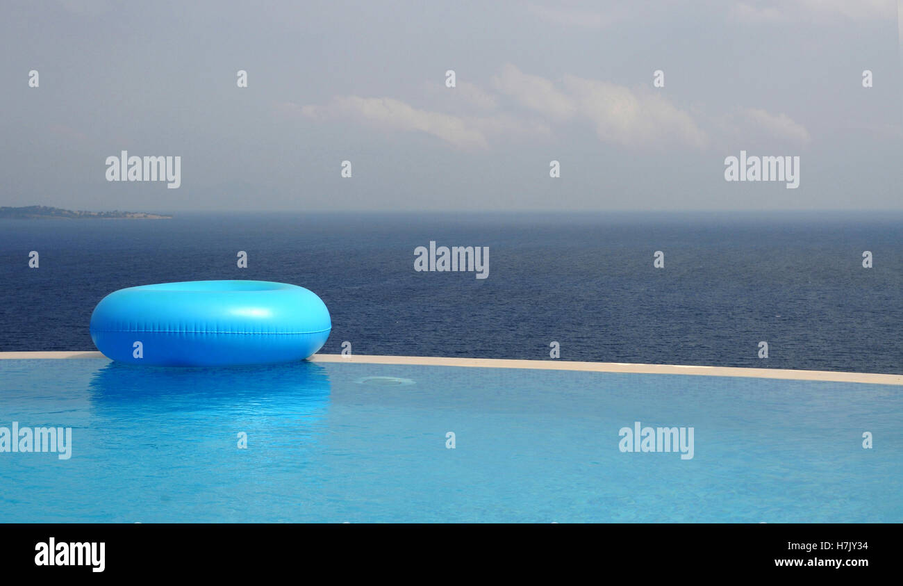 rubber ring floating at the edge of an infinity pool Stock Photo