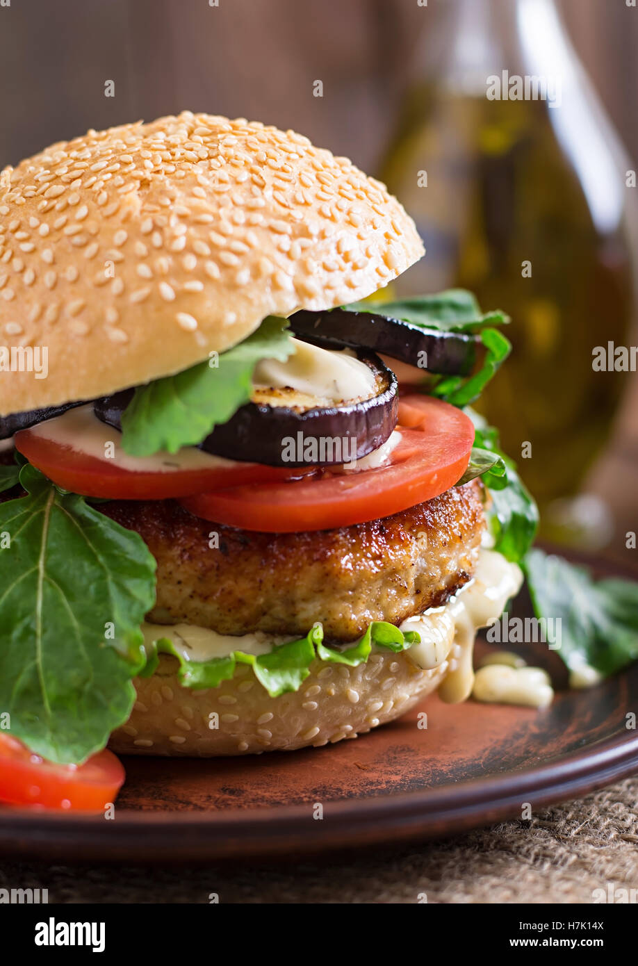 Juicy spicy chicken burgers with tomato and eggplant - sandwich. Stock Photo
