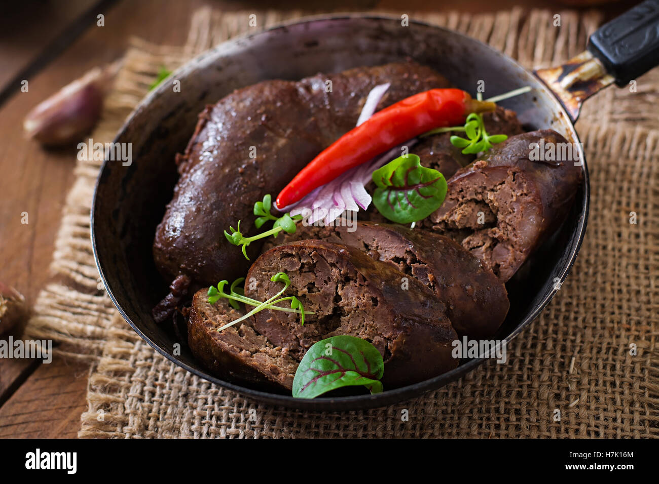 Homemade blood sausage with offal on the old wooden background in rustic style Stock Photo