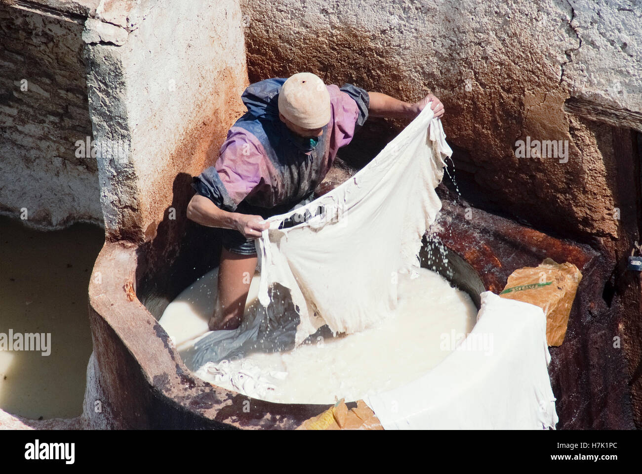 Worker Processing Hides In a White Tanning Pool At A Traditional