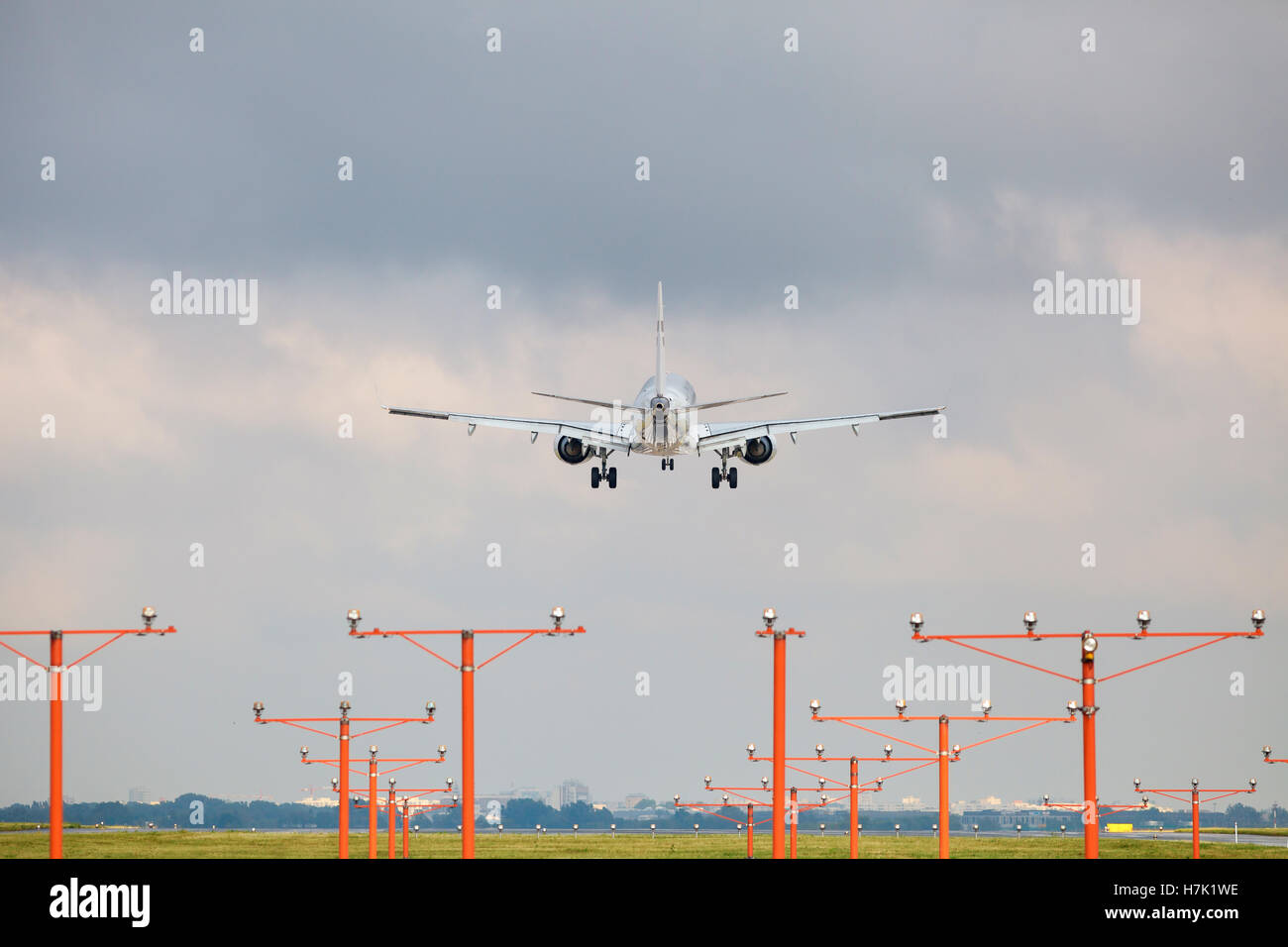 Landing airliner under moody sky Stock Photo