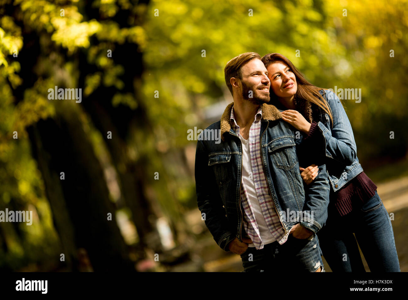 Young loving couple having a walk in the autumn park Stock Photo - Alamy