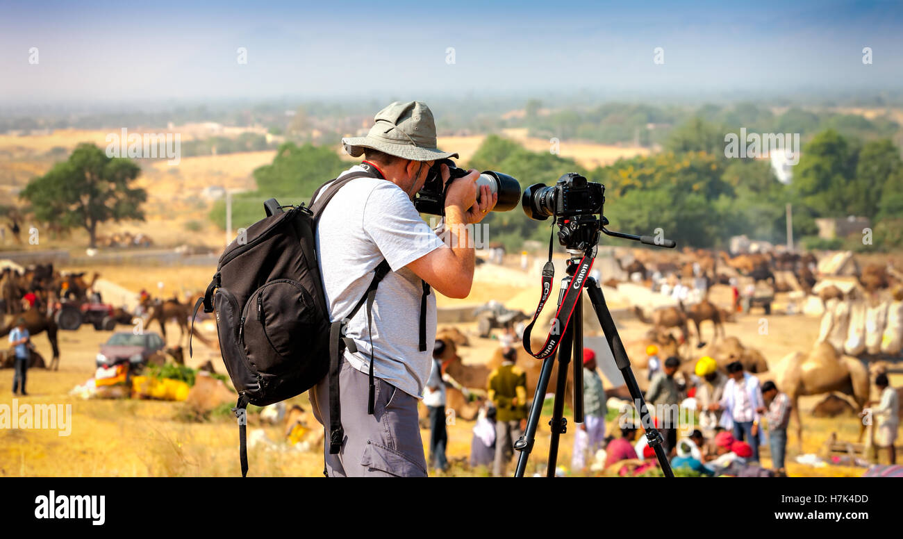 PUSHKAR, INDIA - NOVEMBER 21, 2012: Photographer take pictures at the Pushkar Fair (Pushkar Camel Fair, Pushkar Mela). Stock Photo