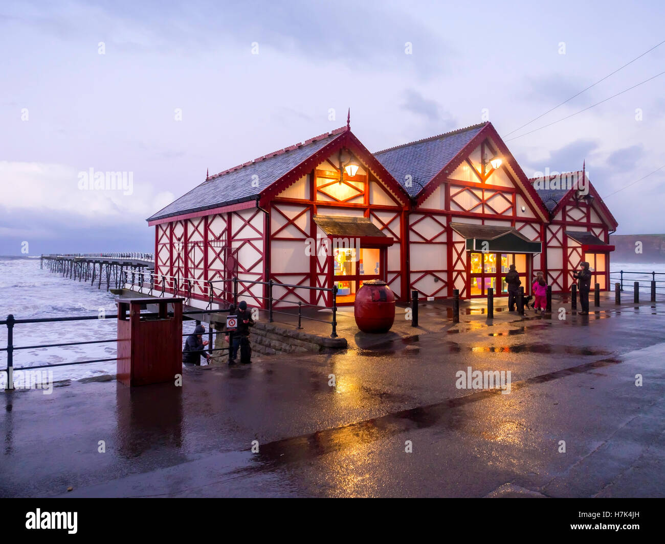 Saltburn Pier in evening light during an Autumn storm with a gale of wind and rough sea Stock Photo