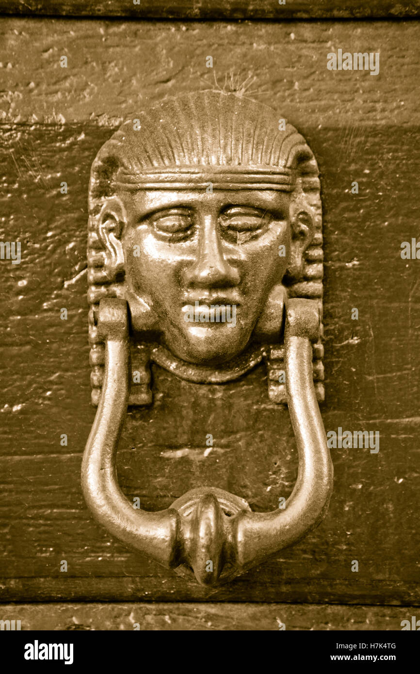 knocker head of antique metal egypt pharaoh of old wooden door Stock