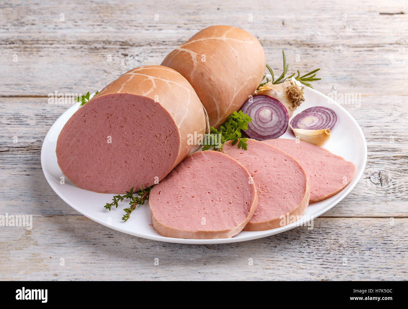 Sliced boiled ham sausage on white plate Stock Photo