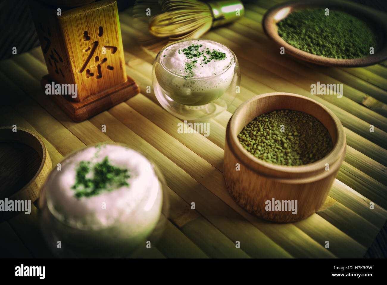 Matcha latte in a glass cup with matcha powder Stock Photo