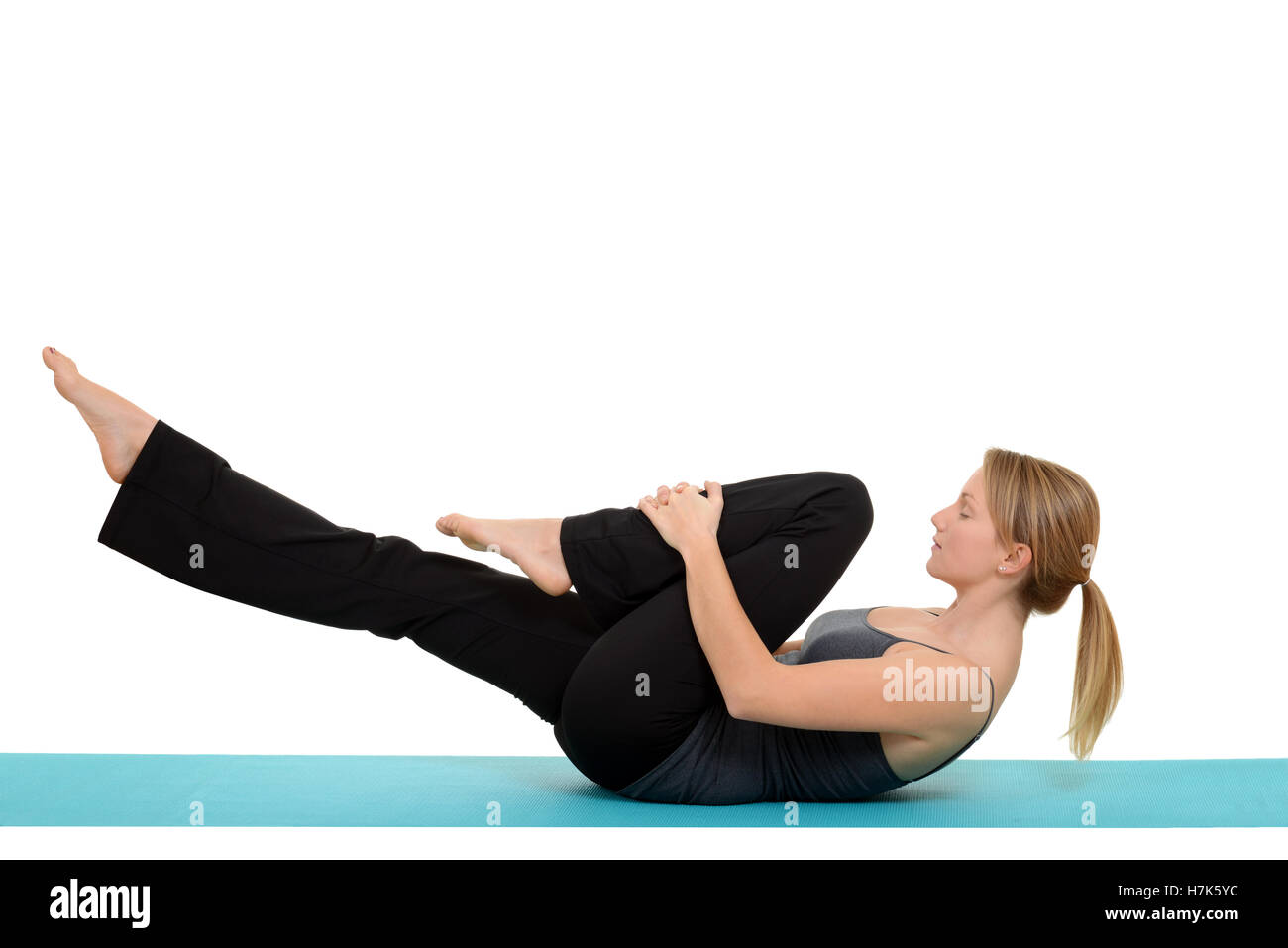 woman doing Pilates single leg stretch Stock Photo - Alamy