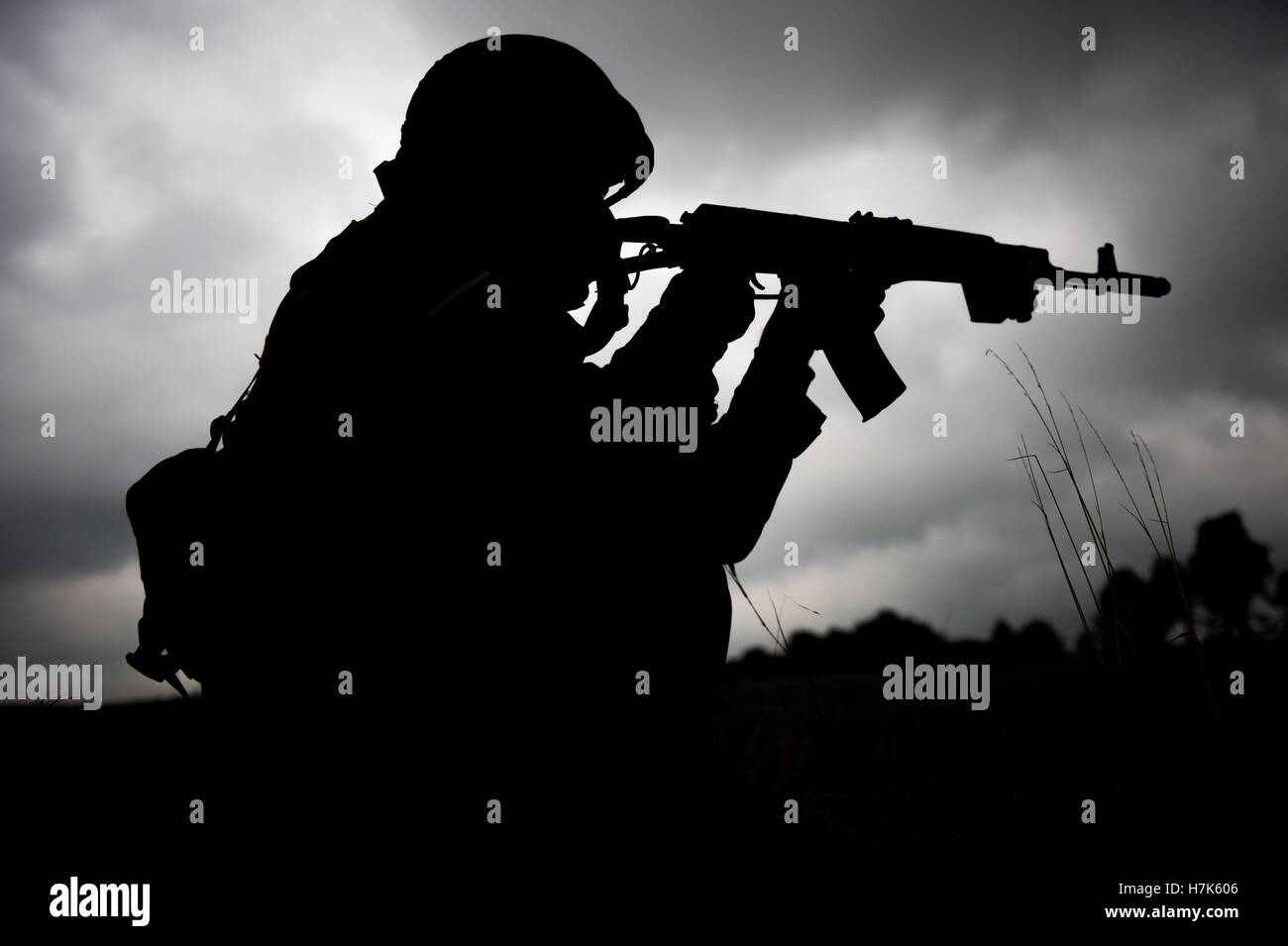 The silhouette of a Bulgarian soldier with his rifle during exercise Rapid Trident at the International Peacekeeping and Security Center September 23, 2014 in Yavoriv, Ukraine. Stock Photo