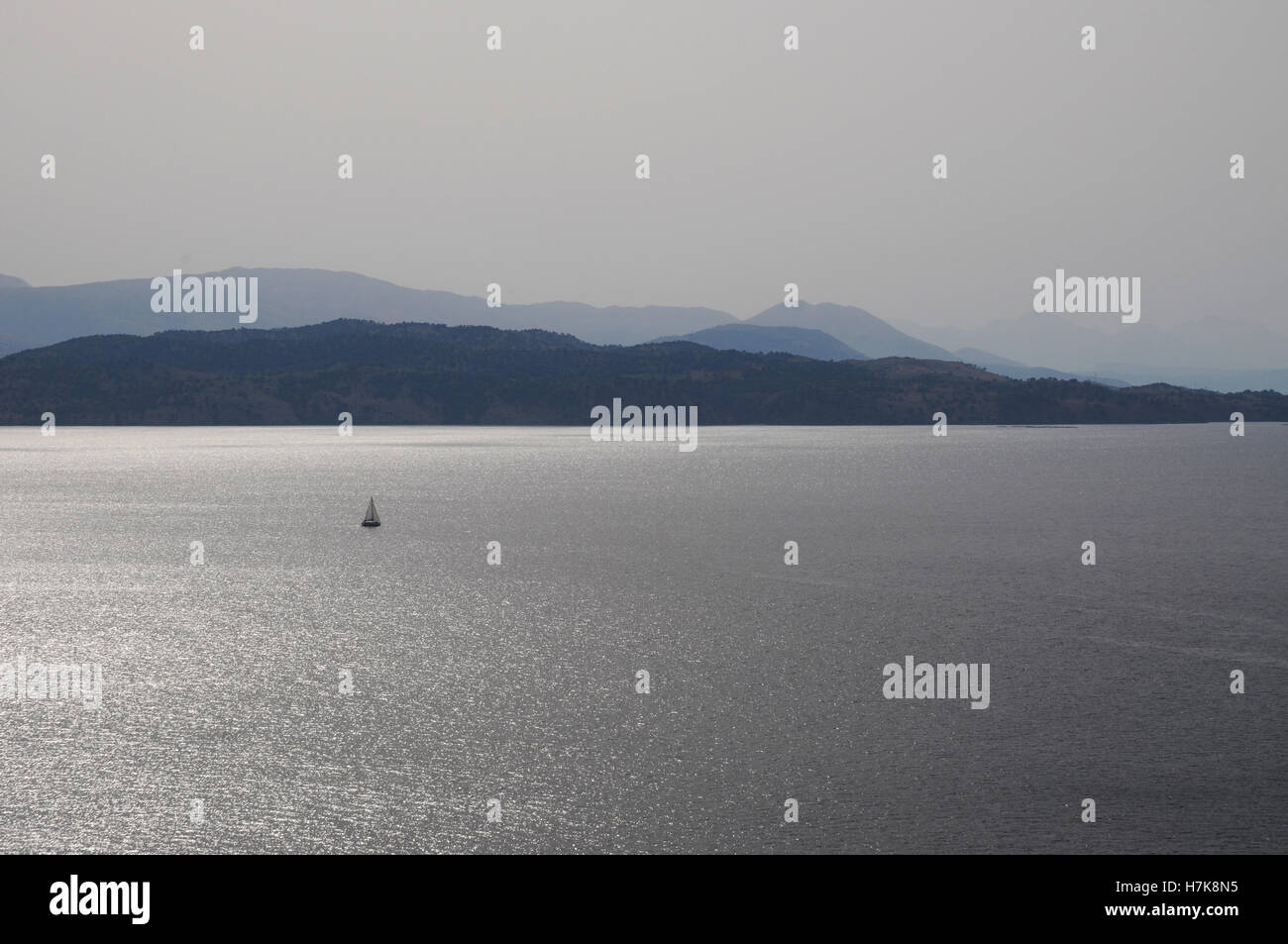 atmospheric view of boats on the mediterranean sea at dusk between Greece and Albania Stock Photo