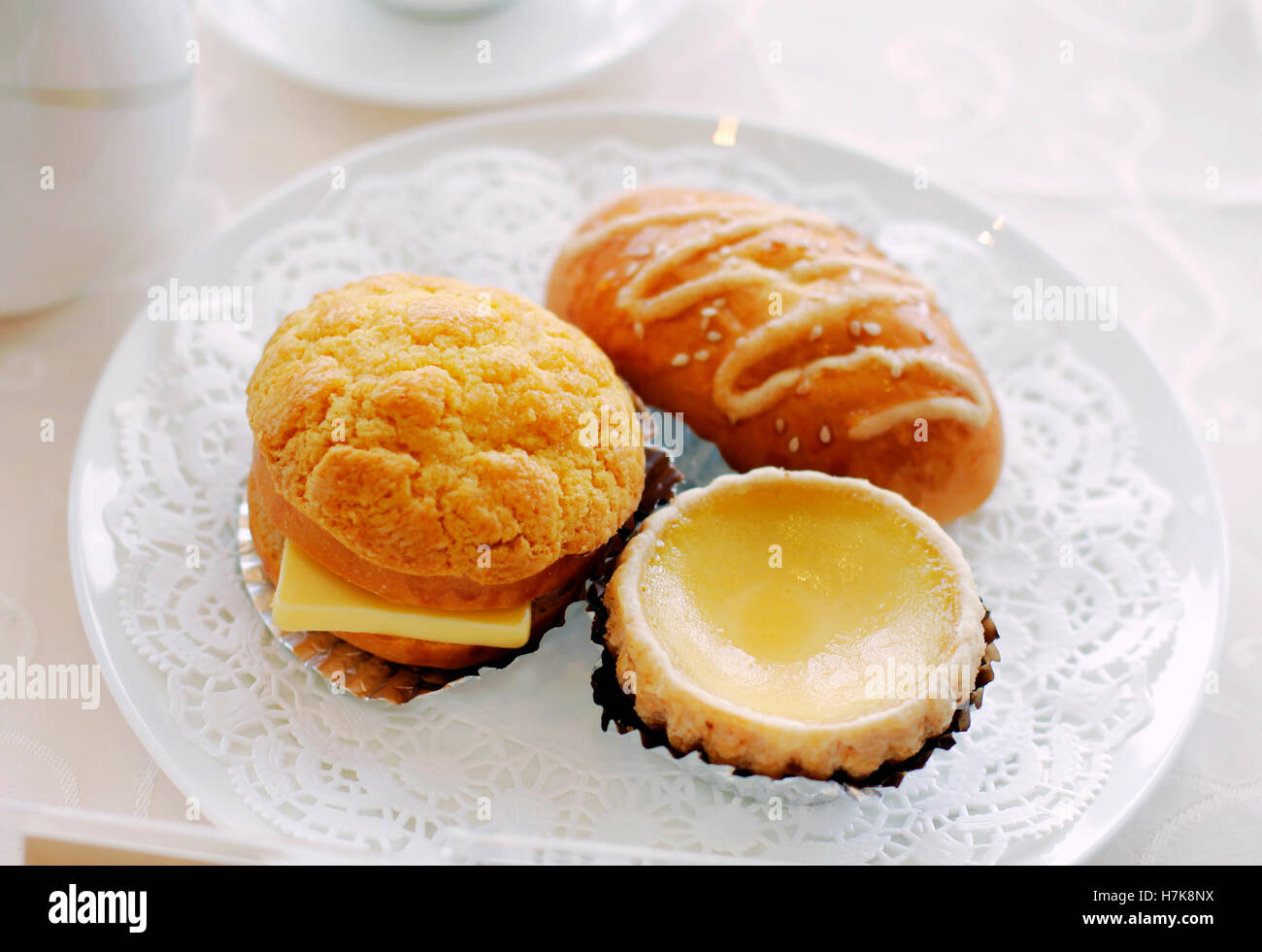 Classic pineapple bun, egg tart and BBQ bun served in Hong Kong Stock Photo