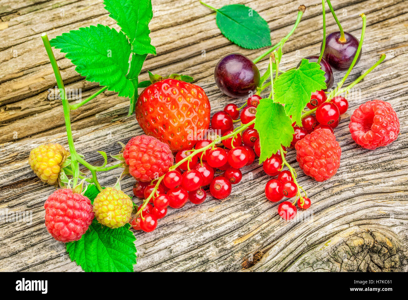 Raspberry,cherry and red currant with leaves on a old wood Stock Photo ...