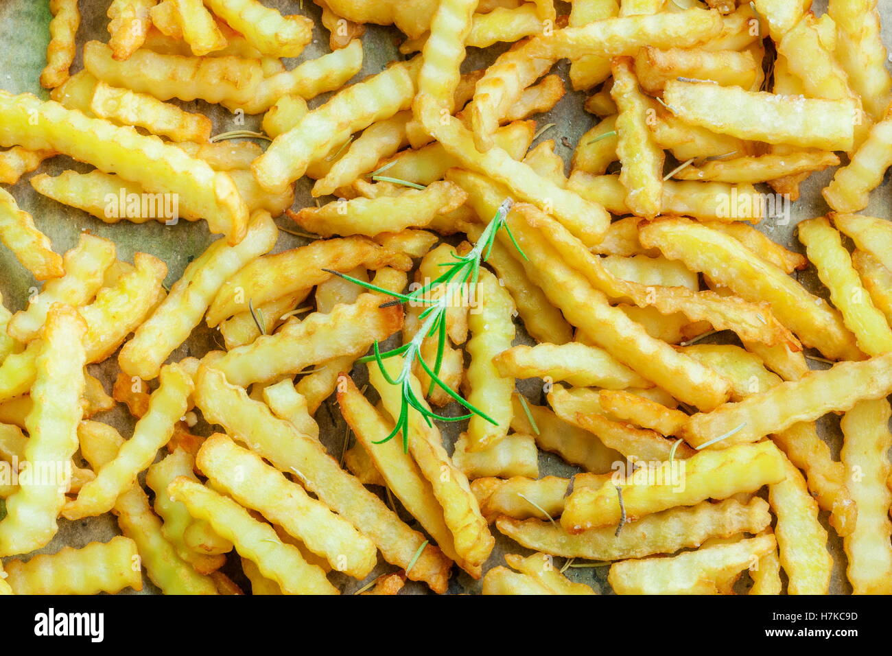 French fries with rosemary on paper Stock Photo Alamy