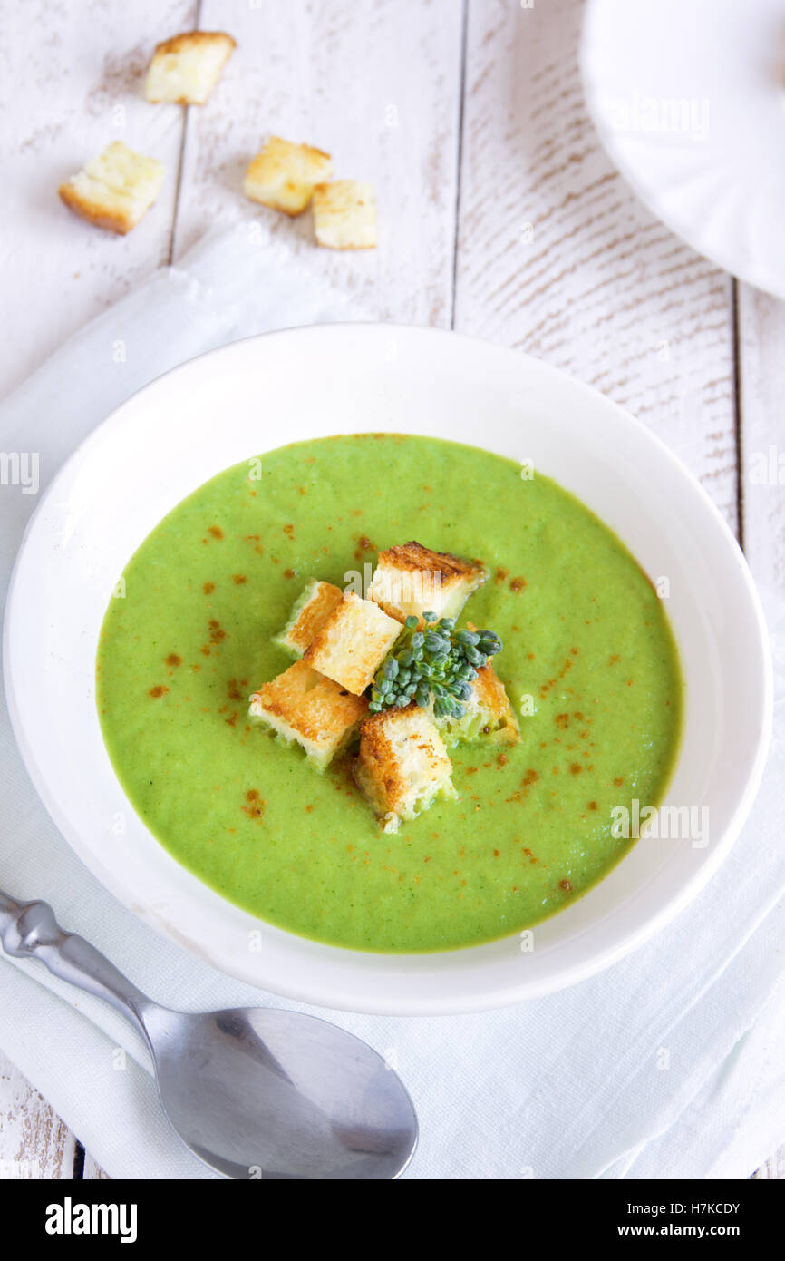 Homemade spicy broccoli cream soup with croutons in white bowl ...