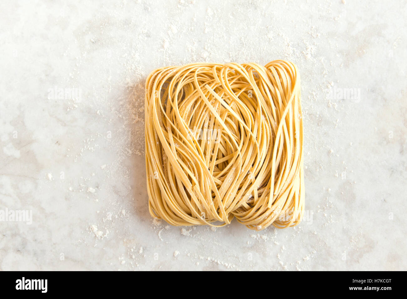 Raw uncooked homemade italian pasta tagliatelle (chinese egg noodles