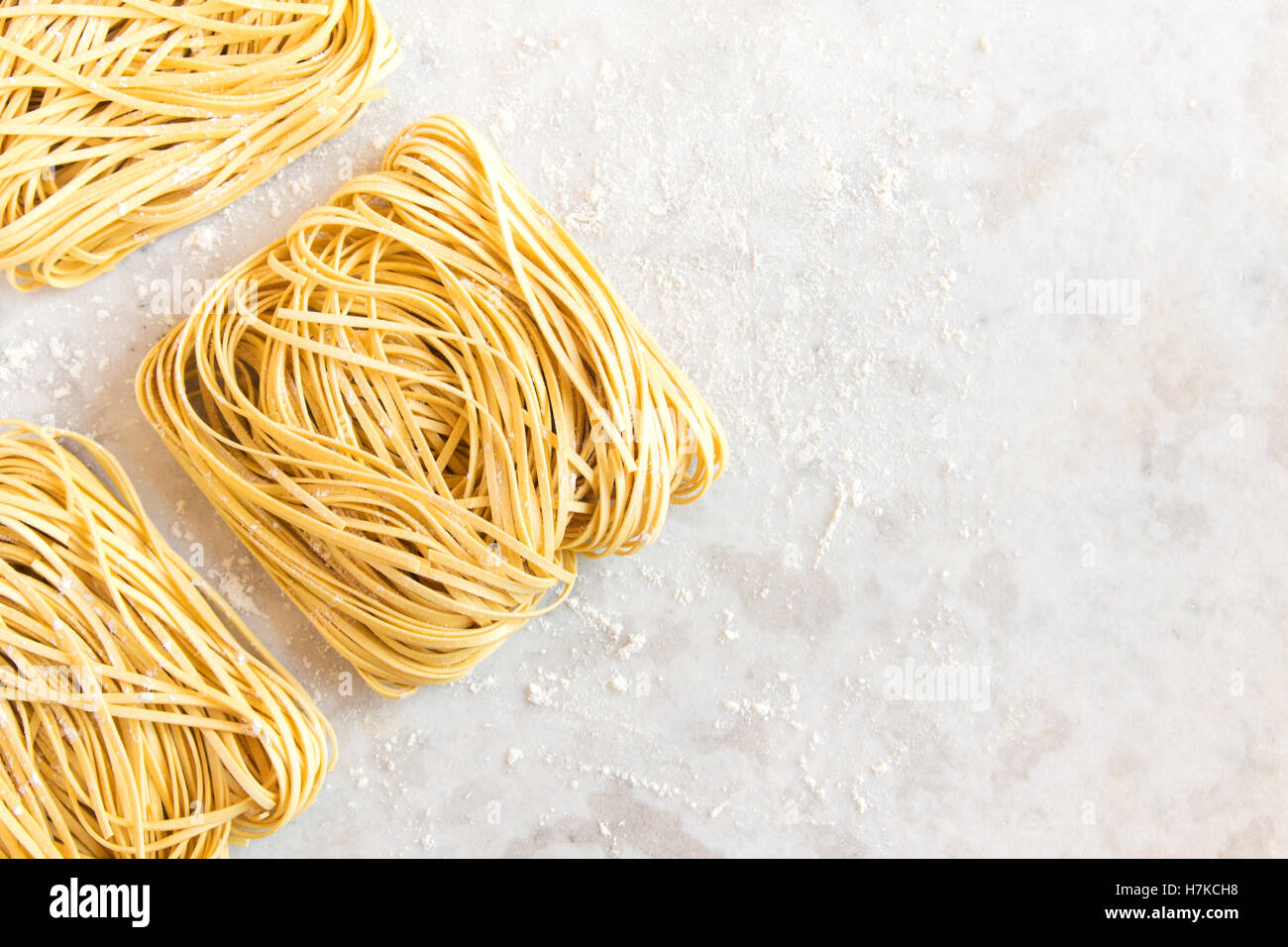 Raw uncooked homemade italian pasta tagliatelle (chinese egg noodles