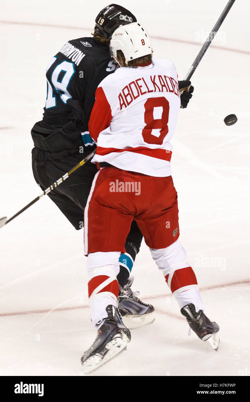 March 3, 2011; San Jose, CA, USA;  Detroit Red Wings left wing Justin Abdelkader (8) knocks San Jose Sharks center Joe Thornton (19) off the puck during the first period at HP Pavilion. Stock Photo