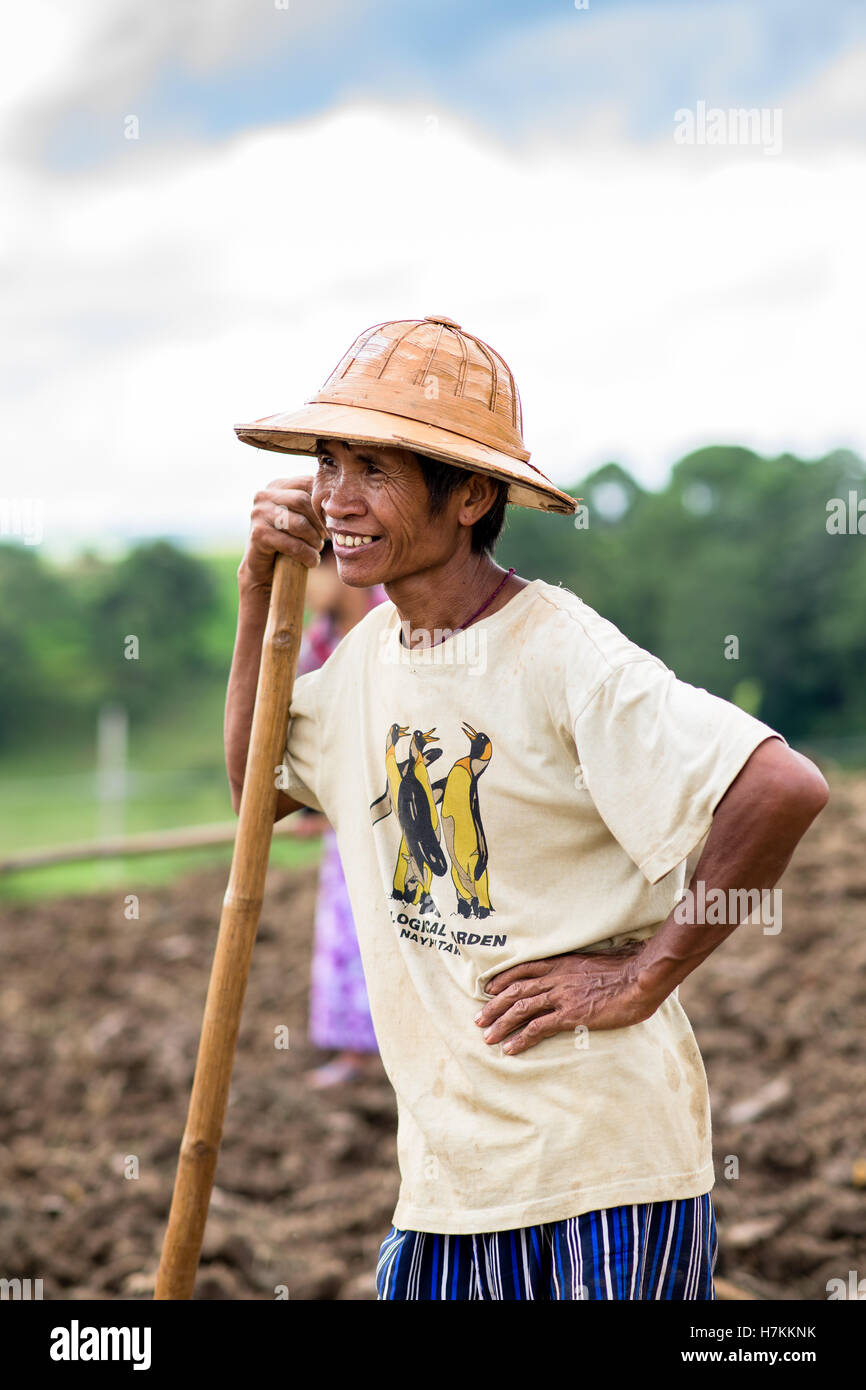 Burmese farmer working the field Stock Photo