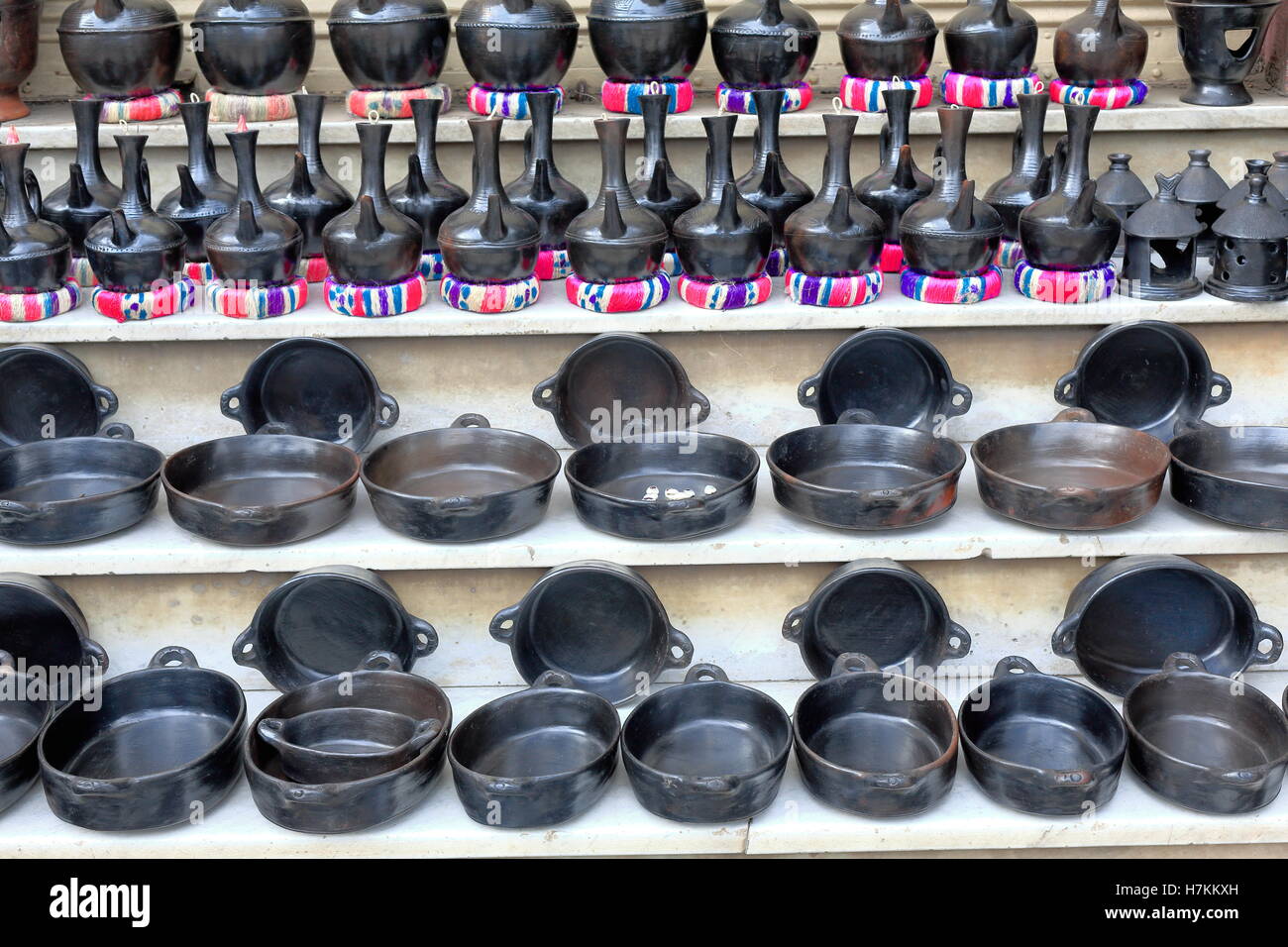 Black pottery jebenas-containers for boiling the buna-traditional Ethiopian coffee along with pans for the toasting of the beans Stock Photo