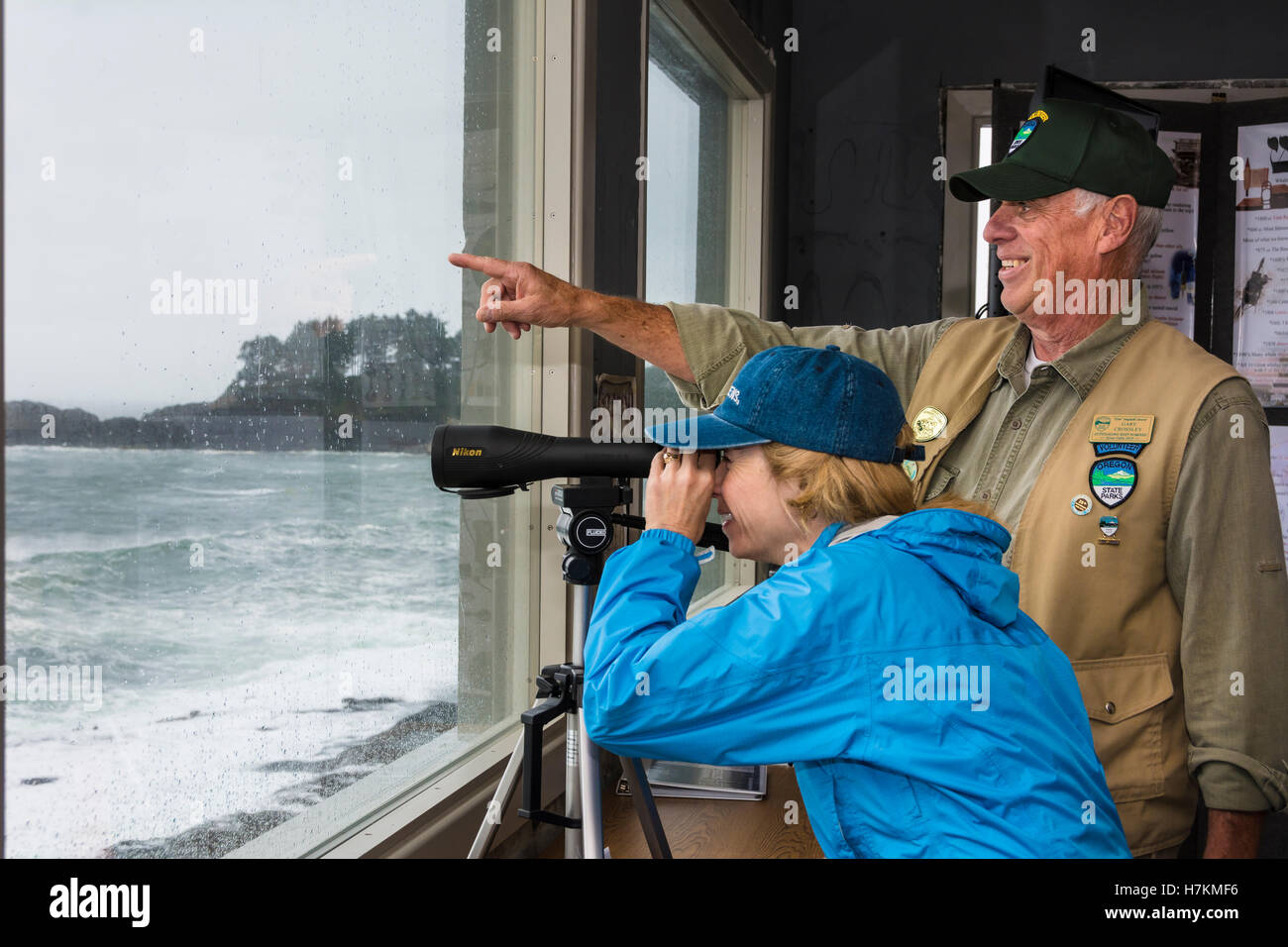 State Parks Volunteer helping visitor search for seabirds and whales