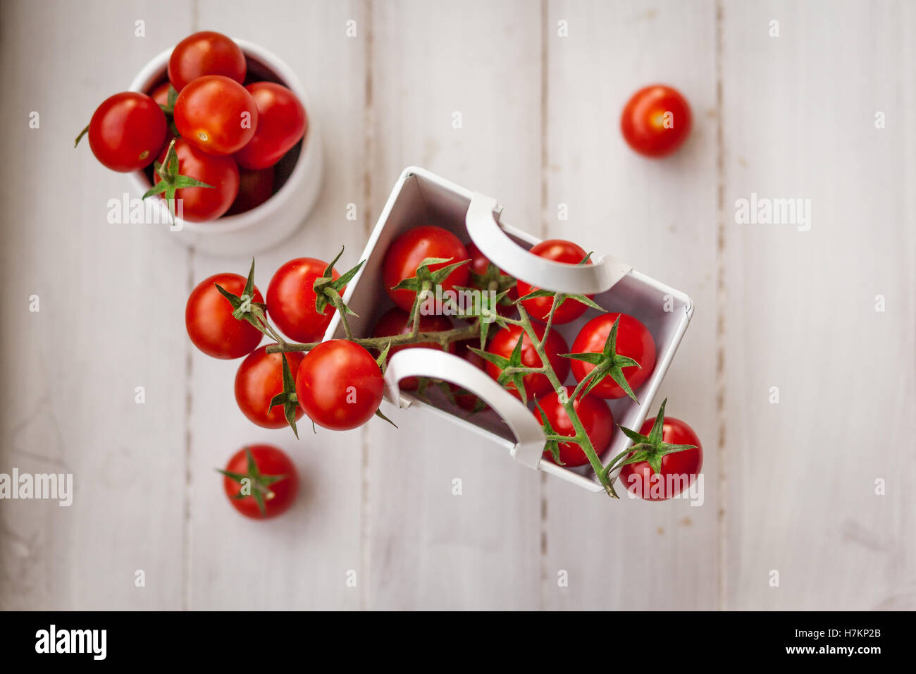 Bunch of ripe cherry tomatoes placed in a wooden table Stock Photo - Alamy