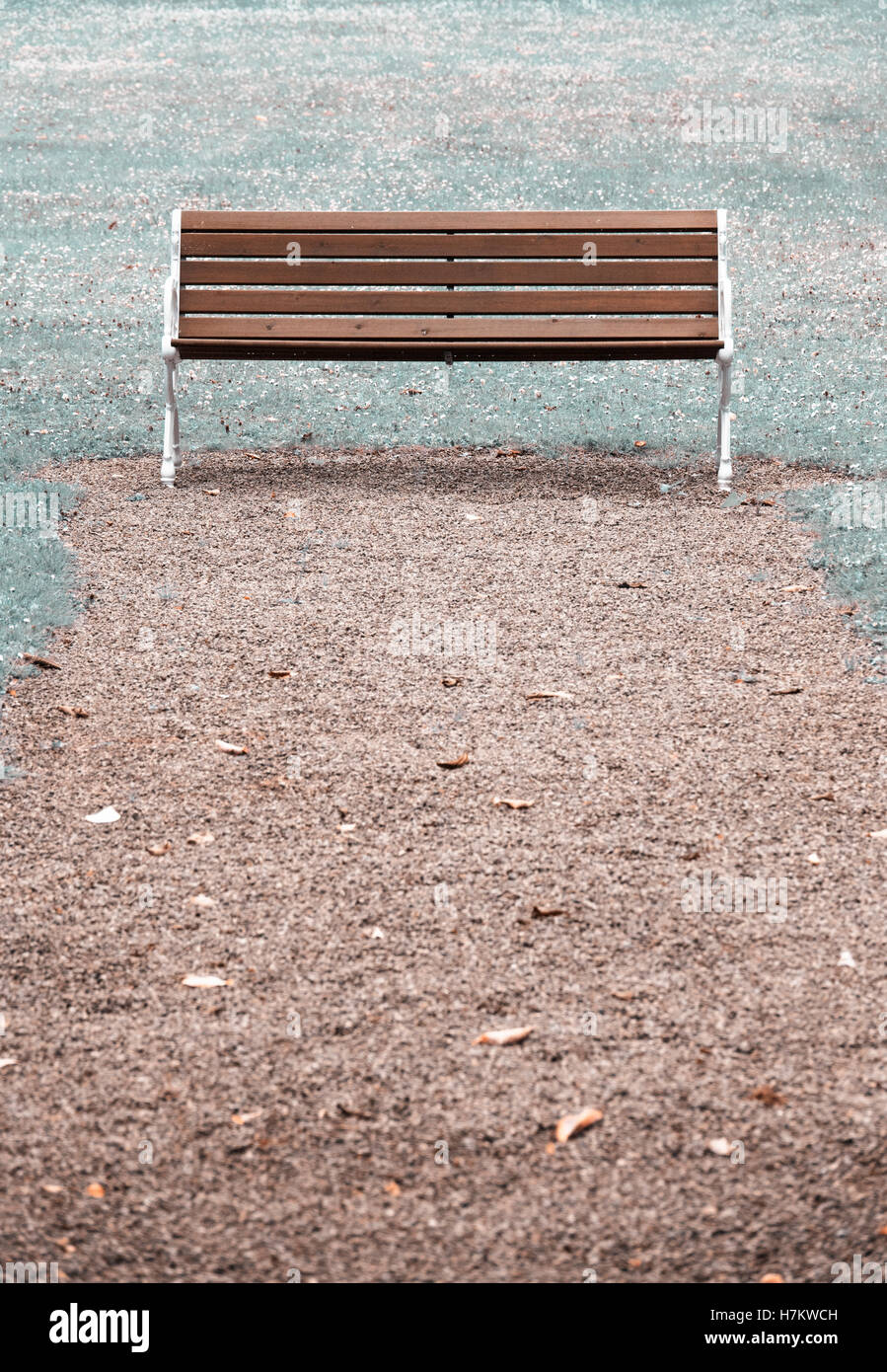 Empty wooden park bench. Concept of absence, emptiness and tranquility Stock Photo