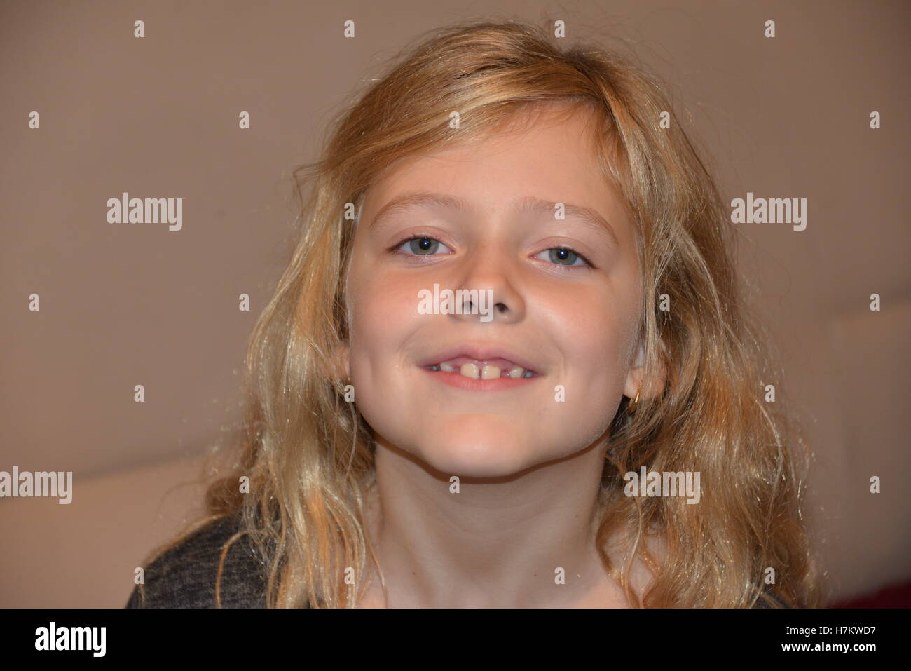 head shots of young girl aged 8 years smiling Stock Photo