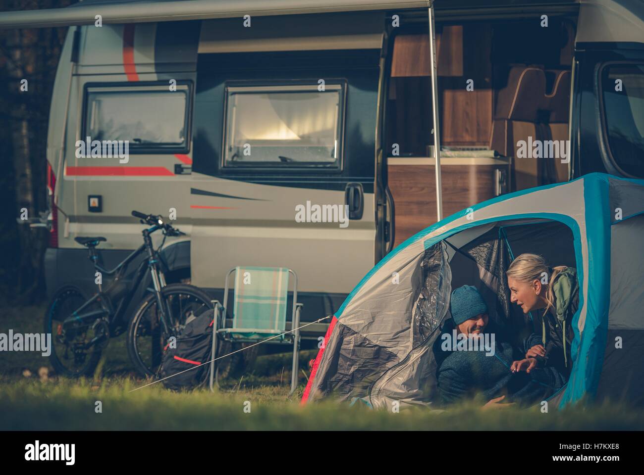 Romantic Couples Tent Camping. Young Caucasian Couples Having Fun Inside Their Tent on the Campground. Stock Photo