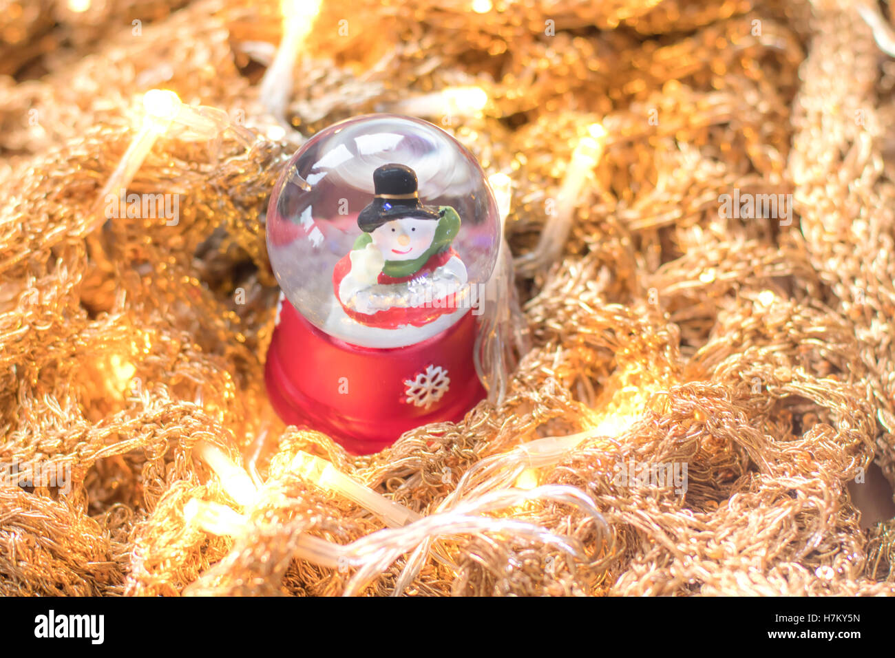 Snowman in snowglobe/snowball on golden, glittery runes with led lights ...